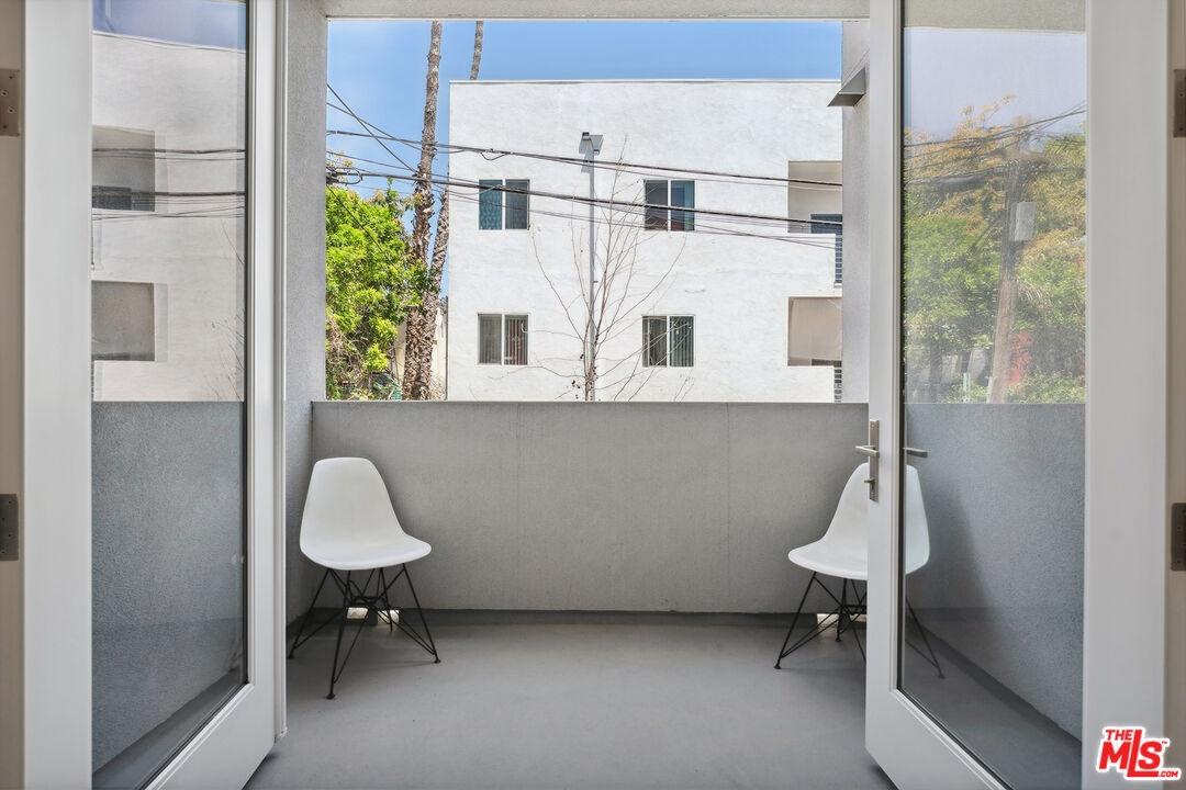 Walk- out covered balcony off