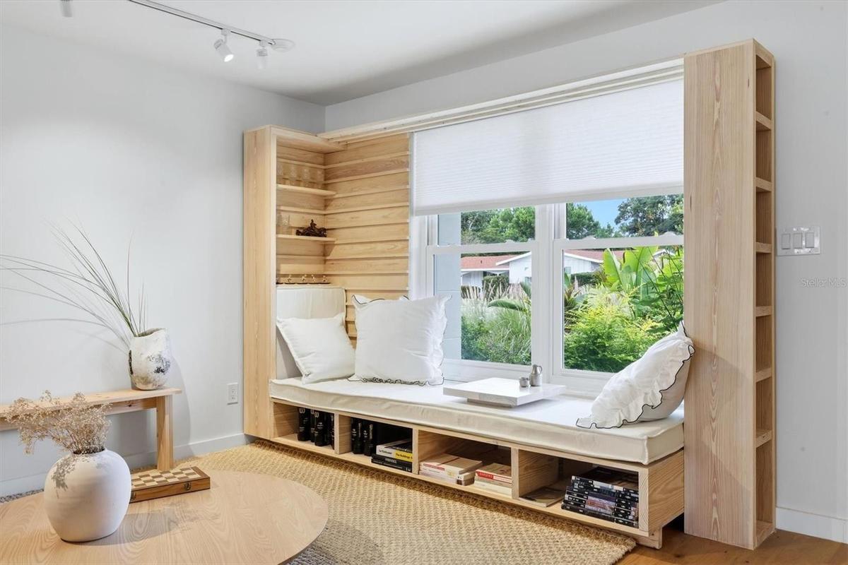 On the right side, the living/family room begins with a beautifully hand-crafted window seat.