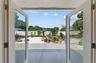 From this room, the inside spaces seamlessly connect with the outside, through window doors that fully open to the yard.