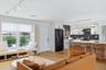Step into the home through the front entrance and to the left see a brand new open kitchen with a ceramic and stone backsplash, quartz countertops, al
