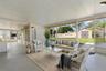 The screened lanai opens directly to the backyard, creating a generous covered space for dining, lounging, or entertaining, with easy access to the la