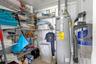 A dedicated utility and storage room keeps household essentials organized with extensive wire shelving and a water heater (2025) tucked neatly to one 