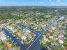 A dramatic aerial view captures Baywood Village’s interconnected canal system and the boating lifestyle that defines the neighborhood, with waterfront