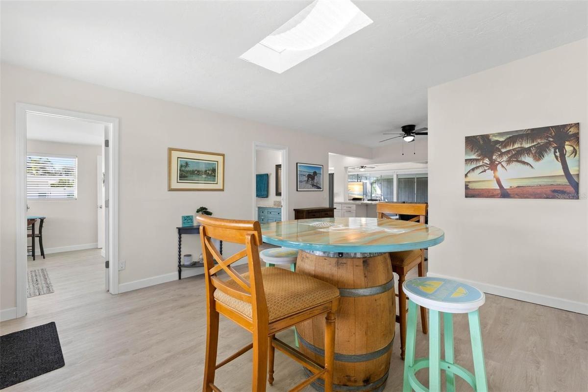 The spacious dining area is filled with natural light from the skylight and flows easily into the adjoining kitchen and living spaces, with 2025 luxur