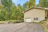 Siding exterior with a built-in garage and white garage door