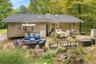 Exterior with horizontal siding, a dark shingle new roof, and patio