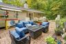 Expansive paver patio with a built-in outdoor Tiki bar and a large outdoor dining area
