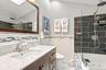 White undermount sink with a single-handle faucet, set into a marble-look countertop