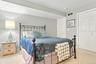 Plush carpeting, neutral wall color, and a white six-panel door