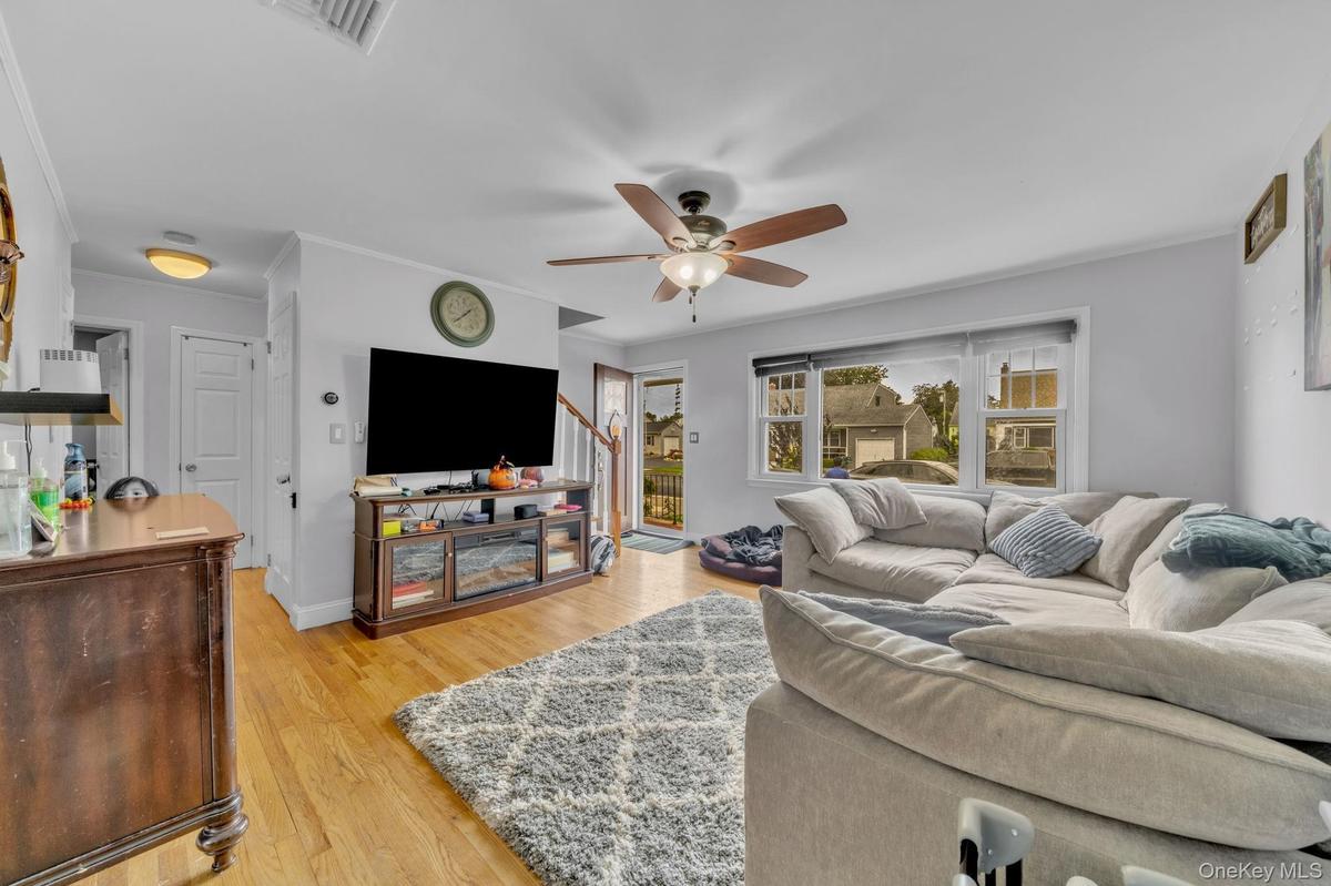 Hardwood flooring, recessed lighting, ceiling fan with integrated lighting, and multiple windows