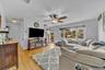 Hardwood flooring, recessed lighting, ceiling fan with integrated lighting, and multiple windows