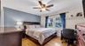 Hardwood flooring, ceiling fan with light fixture, double windows.