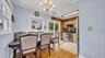 Wood-finish flooring, multiple windows, kitchen with stainless steel appliances, brick-finish kitchen wall, sliding glass patio door