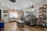 Bay window with multiple panes, wood-finish flooring, recessed lighting, and built-in shelving