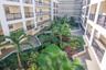 The building features a beautiful open courtyard with lush landscaping and tranquil fountains.