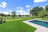 Swimming pool with a light-colored paved surround
