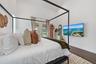 Vaulted white ceilings, wood-finish flooring, and white walls