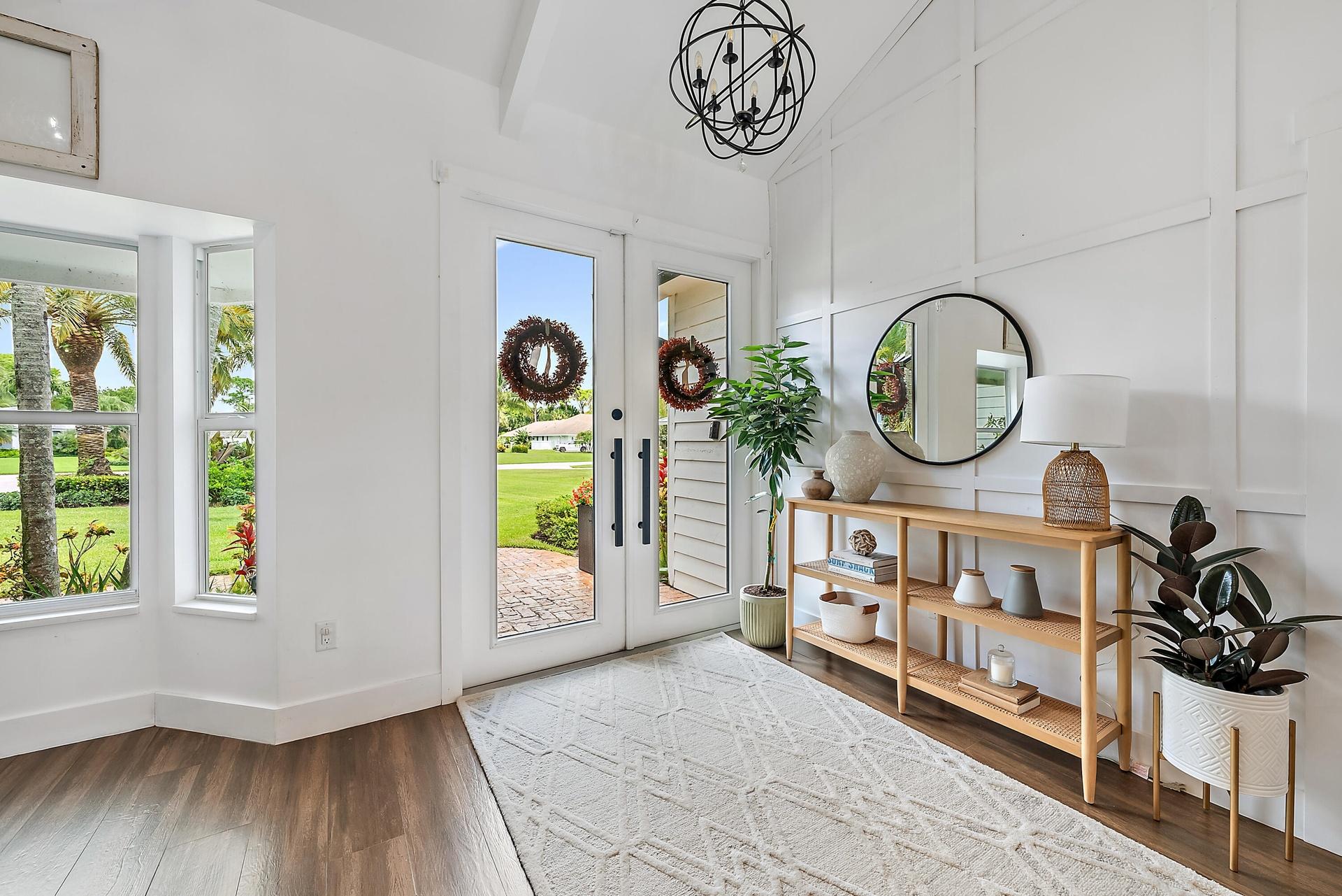 Wood-look tile flooring with a white board and batten accent wall