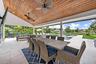 Covered patio with a natural wood-finish vaulted ceiling and integrated ceiling fans