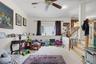 Carpeted flooring, ceiling fan, recessed lighting, and a wood-finish staircase with white risers