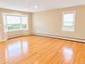 Bay window, hardwood flooring, recessed lighting, and neutral wall tones