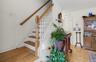Hardwood flooring and a staircase featuring white painted risers with wooden treads and handrails