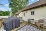 Expansive outdoor deck featuring wood flooring, fencing, and a light-colored siding exterior