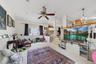 Recessed lighting, ceiling fan, and window with dark drapery