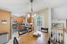 Kitchen featuring light wood-finish cabinetry, stainless steel appliances, and tiled flooring
