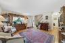 Hardwood flooring, a prominent front entry door, and a built-in staircase with a wood handrail