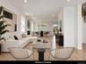 Recessed lighting illuminates wood-finish flooring