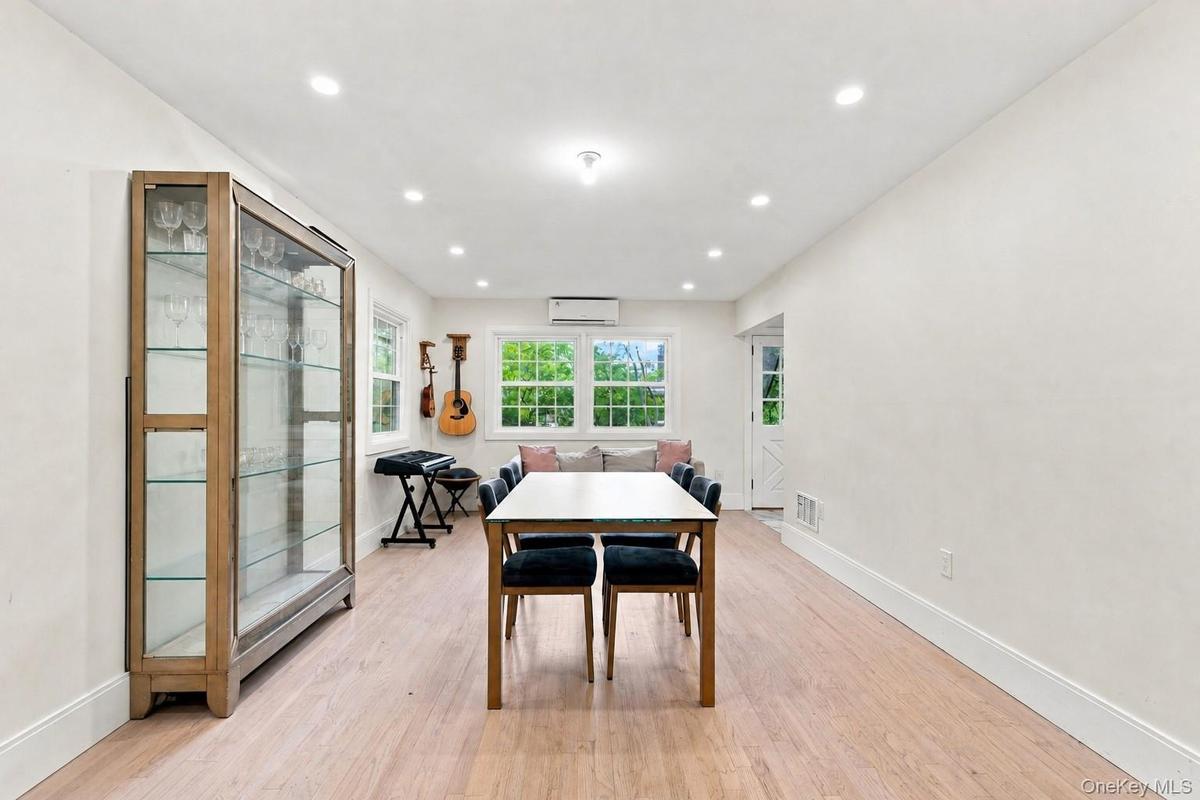 Recessed lighting illuminates the wood-finish flooring