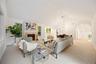 High ceilings, stone fireplace surround, abundant natural light, & understated elegance.