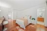 King-sized primary bedroom with large closet, ensuite bathroom, and additional exit to the private patio.