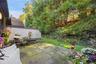 Secluded private blue stone patio overlooking lush greenery.
