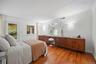 King-sized primary bedroom with large closet, ensuite bathroom, and additional exit to the private patio.