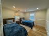 Recessed ceiling lighting, crown molding, wood-finish flooring, two windows with blinds, and wainscoting