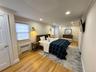 Hardwood flooring, recessed lighting, crown molding, wall-mounted light fixtures, and white paneled doors
