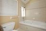 Primary Bathroom with vaulted ceiling and skylight