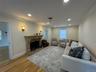 Recessed lighting, crown molding, wood-finish flooring, stone fireplace, and wall sconces