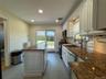 White cabinetry and a center island with a stone countertop
