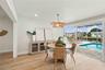 Dining area with views of the water and pool