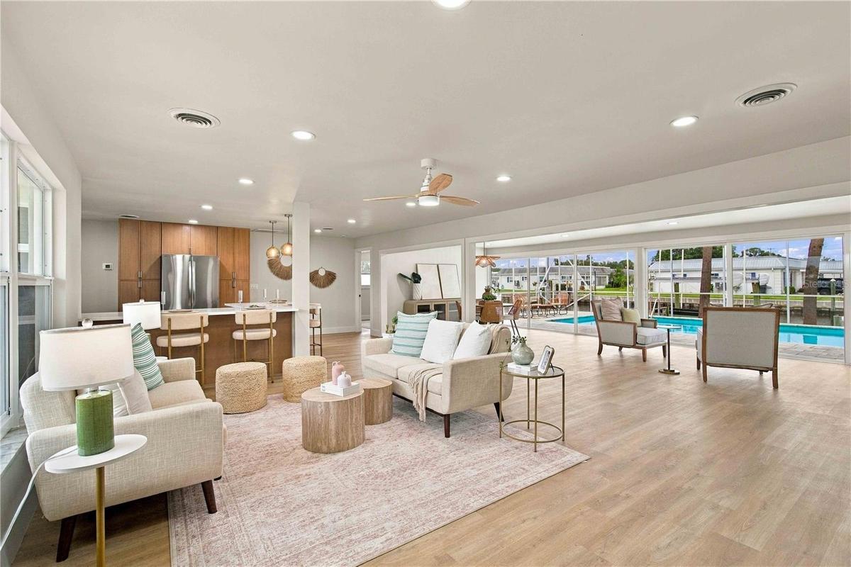 Open concept floor plan with views of the pool and water from anywhere in the Great room, with living room and dining area.
