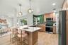 Open kitchen with quartz counters.