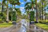 Gated Entry and Extra Long Paved Driveway lined with Palms