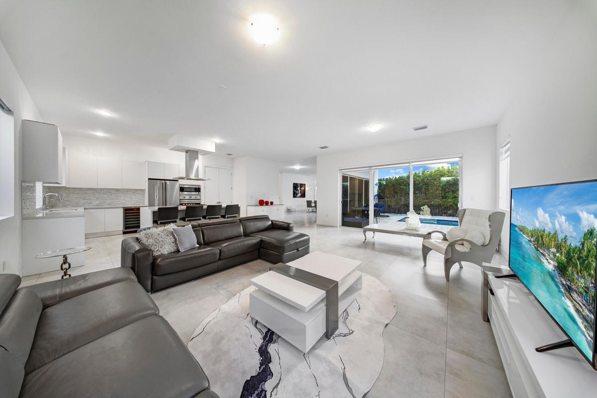 DOWNSTAIRS LIVING ROOM WITH A POOL VIEW