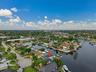 Waterfront property featuring direct canal access, an established neighborhood setting, mature trees, and a private boat dock