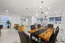 Open-concept living space with recessed lighting and a modern chandelier