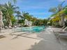 One-acre rooftop amenity deck with resort-style pool, cabanas and tropical landscaping