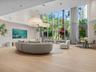 Resident lounge with floor-to-ceiling glass and lush views